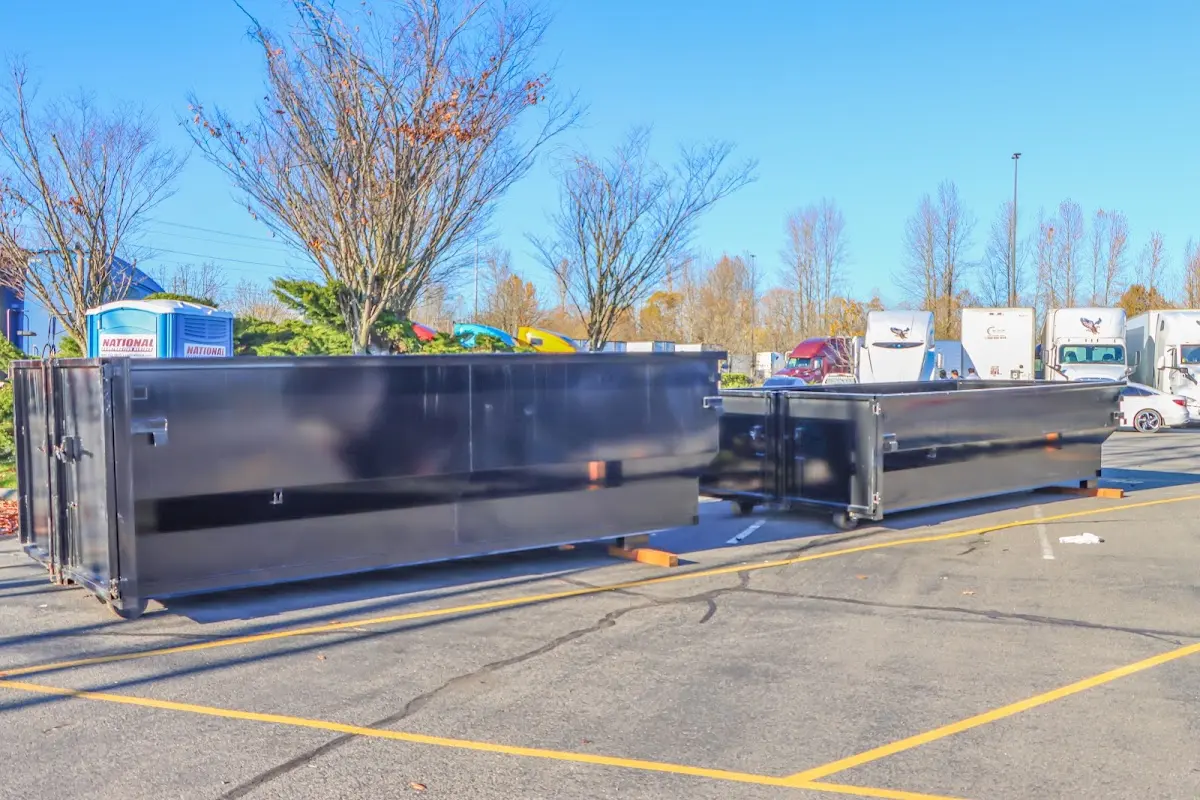 Professional dumpster rental service with roll-off container on residential driveway in Palm Tree